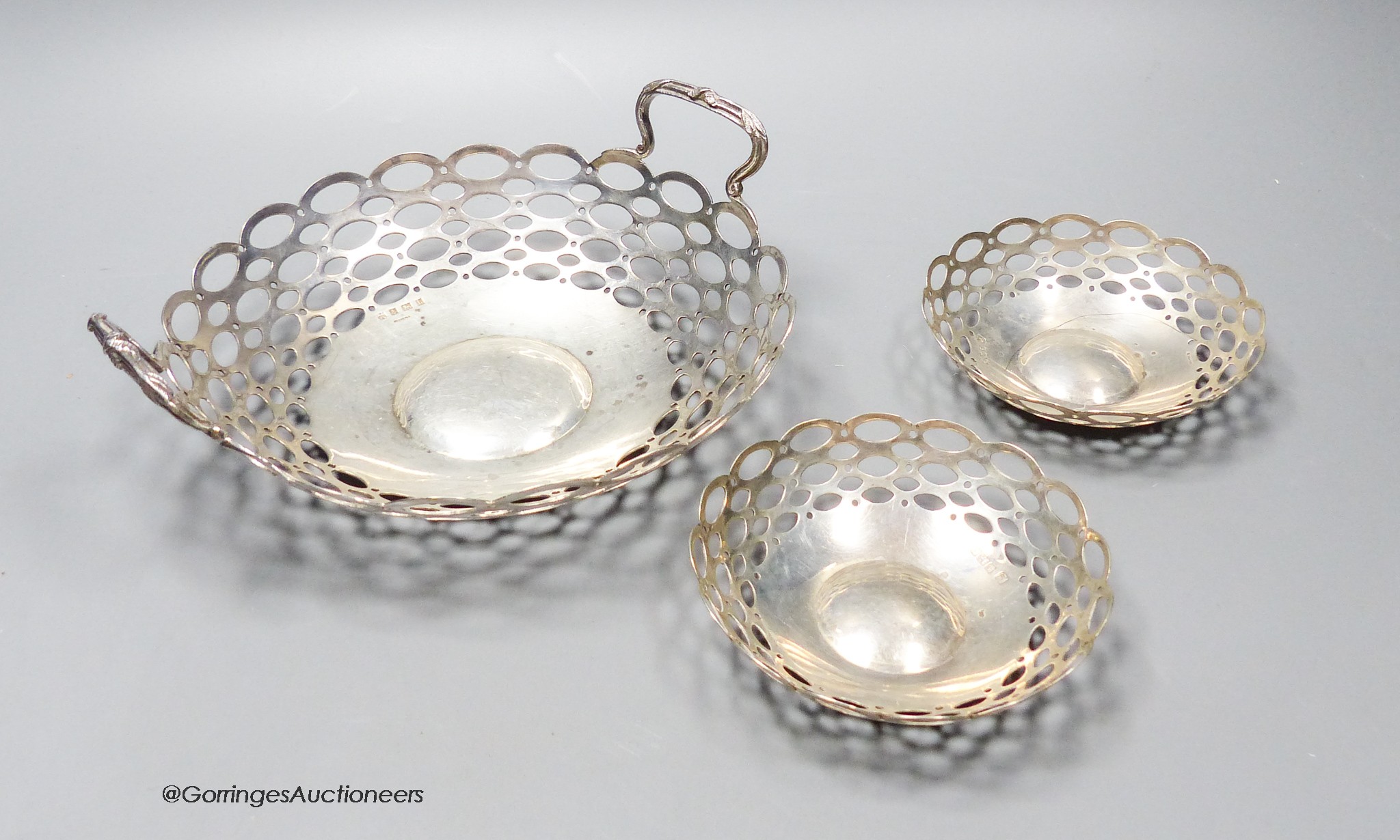 A graduated suite of Edwardian pieced silver bonbon dishes, 19.7cm(1) and 10cm(2), A&J Zimmerman, Birmingham, 1909 & 1914, 8.5oz.